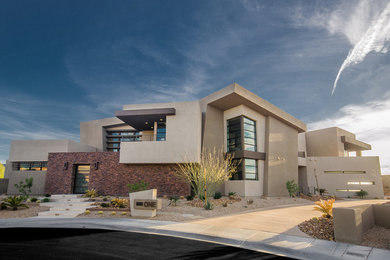 Example of a huge trendy two-story exterior home design in Las Vegas