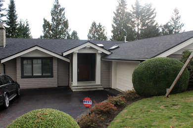 Medium sized and beige traditional two floor house exterior in Vancouver with wood cladding and a pitched roof.