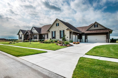 Large rustic beige one-story stone gable roof idea in Omaha