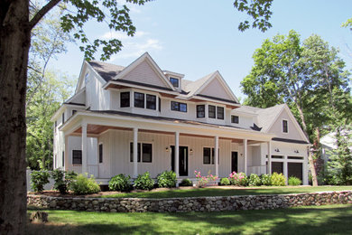 Example of a large farmhouse white mixed siding exterior home design in Boston with a shingle roof
