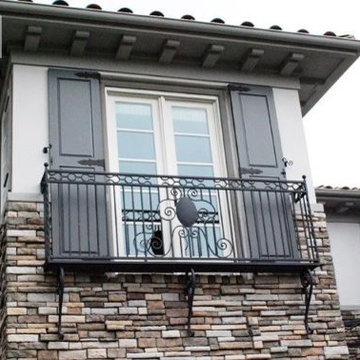 Custom French Door Architectural Shutters Atop a Iron-Forged Balcony