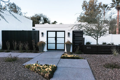 Example of a mid-sized minimalist white one-story stucco flat roof design in Phoenix