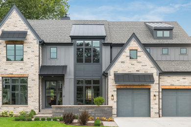 Farmhouse gray two-story house exterior photo in Chicago with a mixed material roof