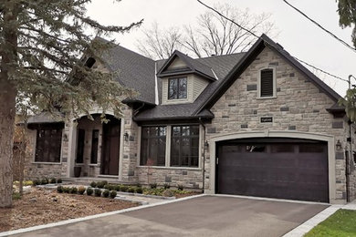Mid-sized traditional gray one-story stone exterior home idea in Toronto with a shingle roof