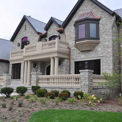 Example of a large classic gray two-story stone exterior home design in Chicago with a shingle roof