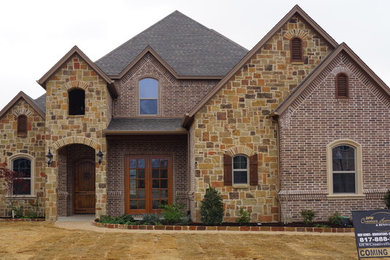 Inspiration for a large timeless brown two-story mixed siding gable roof remodel in Dallas