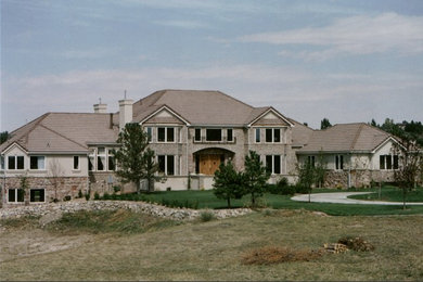 Huge elegant beige two-story stucco exterior home photo in Denver