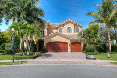 Example of a large tuscan two-story exterior home design in Miami