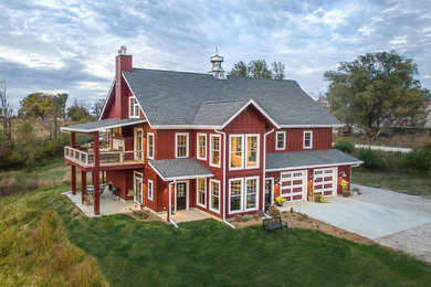 Example of a huge cottage red two-story exterior home design in Other
