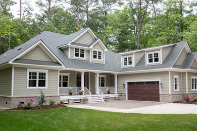 Example of a large arts and crafts beige two-story concrete fiberboard exterior home design in Other with a hip roof