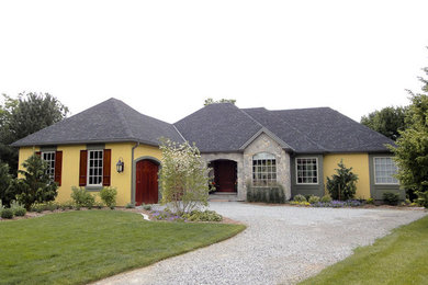Transitional yellow one-story stone house exterior photo in Other