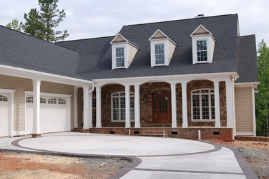 Large transitional beige two-story wood exterior home photo in Raleigh with a shingle roof