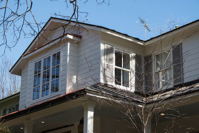Diseño de fachada de casa blanca clásica renovada grande de dos plantas con revestimiento de madera