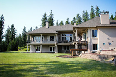 Mid-sized transitional beige two-story stucco exterior home idea in Seattle