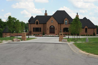 Inspiration for a large transitional brown three-story brick exterior home remodel in Columbus