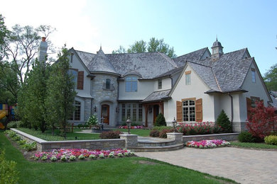 Example of a classic gray two-story exterior home design in Chicago