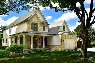 Example of a large classic beige two-story mixed siding exterior home design in Chicago