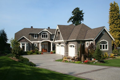 Ejemplo de fachada de casa gris tradicional grande de dos plantas con revestimiento de madera y tejado de teja de madera