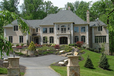Inspiration for a large mediterranean beige two-story mixed siding exterior home remodel in Baltimore with a hip roof