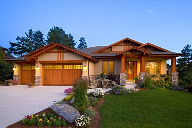 Inspiration for a large timeless beige one-story stucco exterior home remodel in Denver