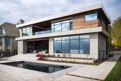 Inspiration for a large contemporary multicolored two-story mixed siding exterior home remodel in Toronto with a green roof