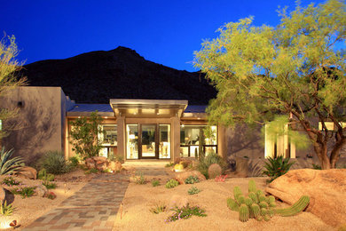 Inspiration for a mid-sized beige one-story adobe exterior home remodel in Phoenix