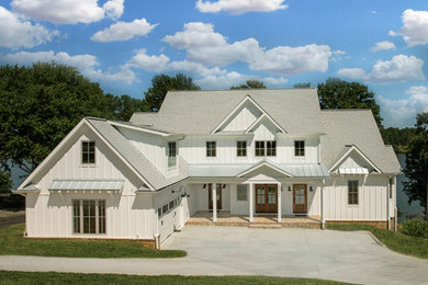 Example of a farmhouse white two-story exterior home design in Charlotte with a shingle roof