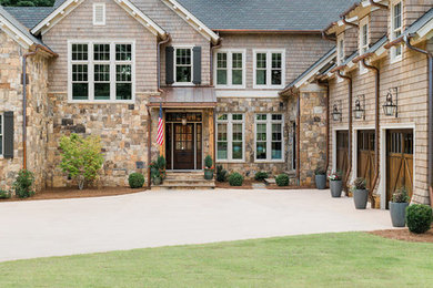 Large beach style brown two-story wood exterior home photo in Atlanta with a shingle roof