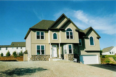 Inspiration for a mediterranean beige two-story stucco exterior home remodel in Philadelphia