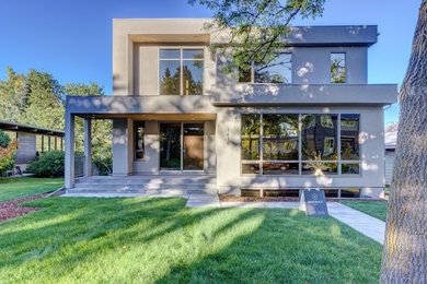 Large minimalist gray two-story stucco exterior home photo in Calgary