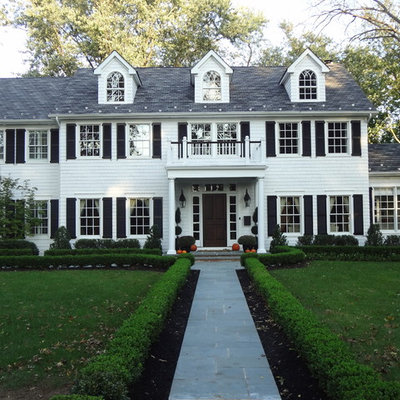 Large elegant white two-story wood gable roof photo in New York