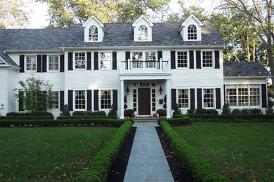 Large elegant white two-story wood gable roof photo in New York