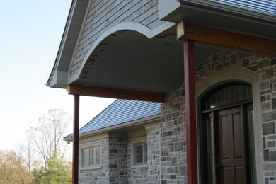 Example of a large classic stone exterior home design in Toronto