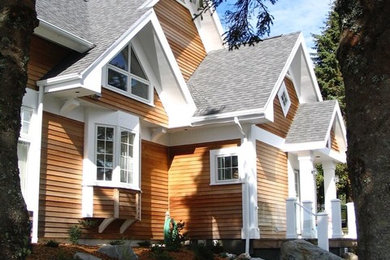 Foto de fachada de casa marrón de estilo americano grande de dos plantas con revestimiento de madera, tejado a dos aguas y tejado de teja de madera