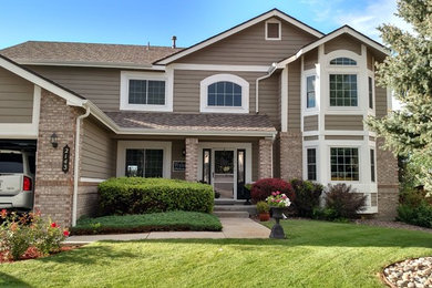 Inspiration for a brown and large classic two floor detached house in Denver with wood cladding and a pitched roof.