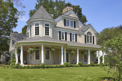 Mid-sized beige three-story wood gable roof idea in New York
