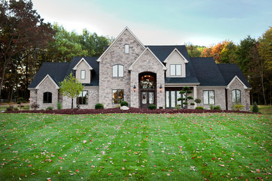 Inspiration for a huge transitional beige two-story mixed siding exterior home remodel in Other