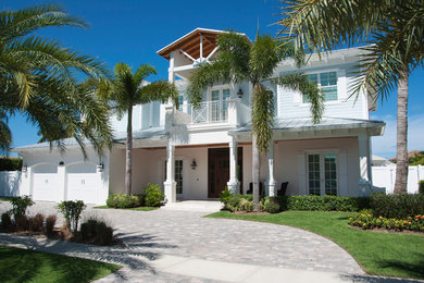 Medium sized and gey nautical two floor detached house in Miami with wood cladding, a hip roof and a metal roof.