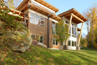 Mid-sized minimalist brown one-story wood exterior home photo in Burlington with a shingle roof