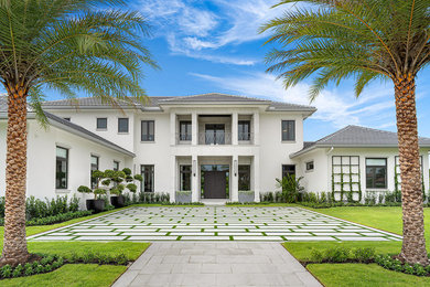 Beach style white two-story house exterior photo in Other with a hip roof