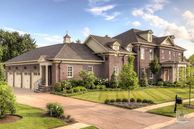 Huge elegant three-story brick house exterior photo in Louisville with a hip roof and a shingle roof