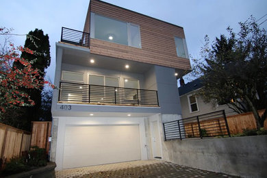 Example of a large trendy gray three-story mixed siding flat roof design in Orange County