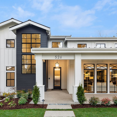 Example of a mid-sized farmhouse white two-story wood exterior home design in Seattle