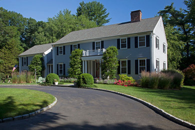 Mid-sized elegant gray two-story concrete fiberboard exterior home photo in New York with a shingle roof