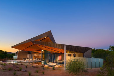 Large southwest multicolored one-story wood house exterior photo in Phoenix with a mixed material roof