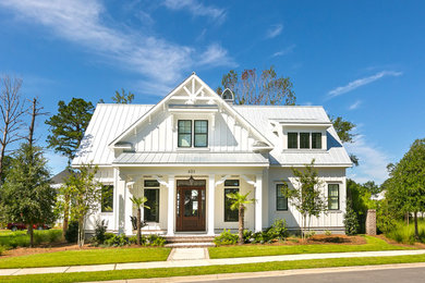 Small beach style white two-story concrete fiberboard exterior home photo in Charleston with a metal roof