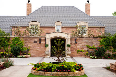 Example of a huge beige two-story stone exterior home design in Oklahoma City with a hip roof