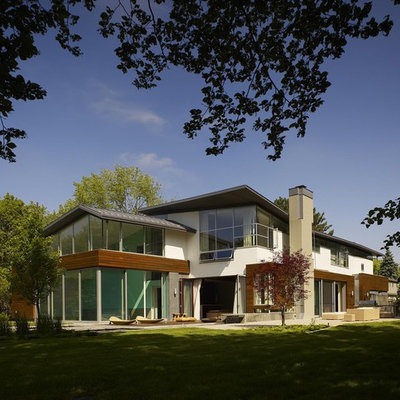 Huge contemporary white two-story wood exterior home idea in Toronto with a shed roof