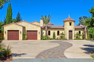 Example of a large tuscan exterior home design in San Diego