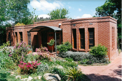 Example of a farmhouse exterior home design in Canberra - Queanbeyan